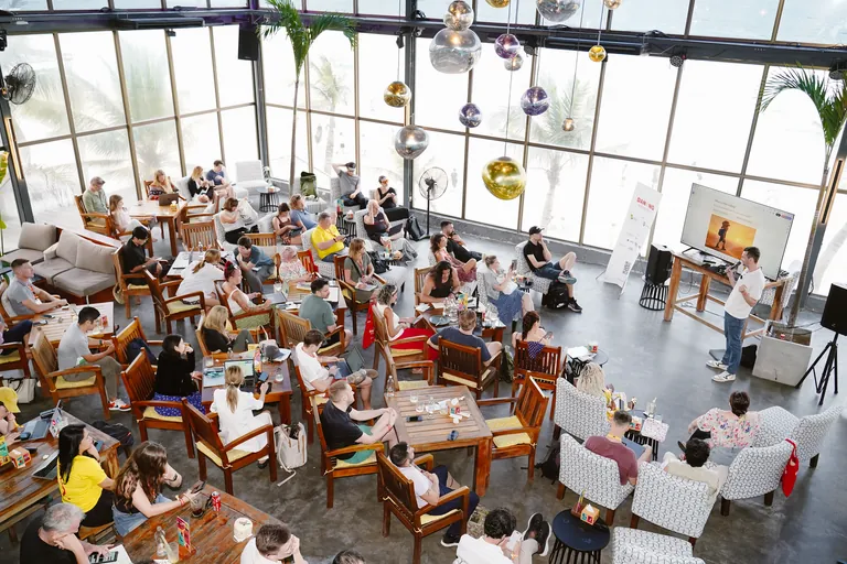 Birds-eye view of a packed room watching Sean present at the Da Nang Digital Nomad Festival